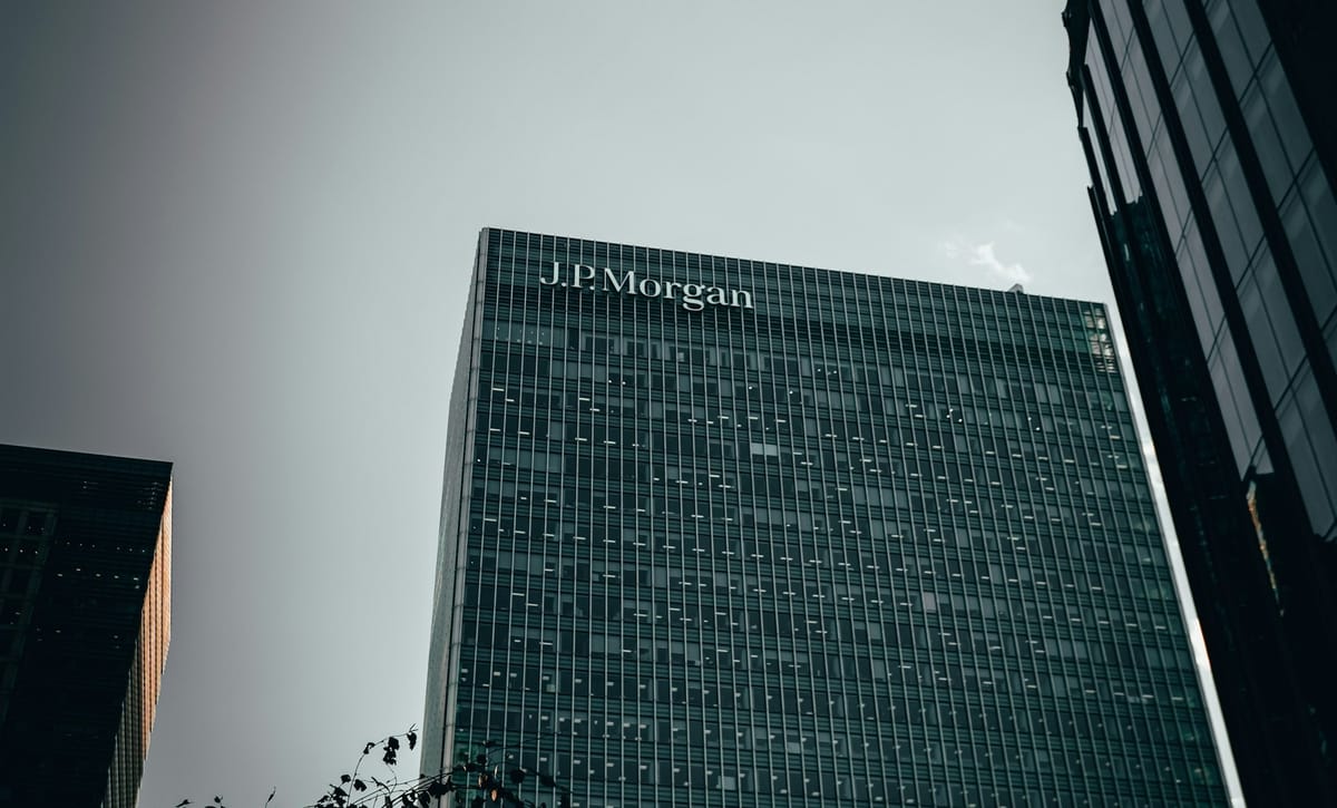 JPMorgan Chase headquarters exterior with financial market data visuals.