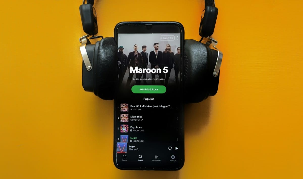 A smartphone displaying the Spotify app interface open on Maroon 5 artist page.