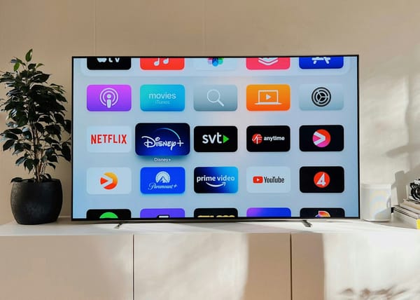 Roku streaming device and remote displayed on a television screen showing a streaming platform interface.